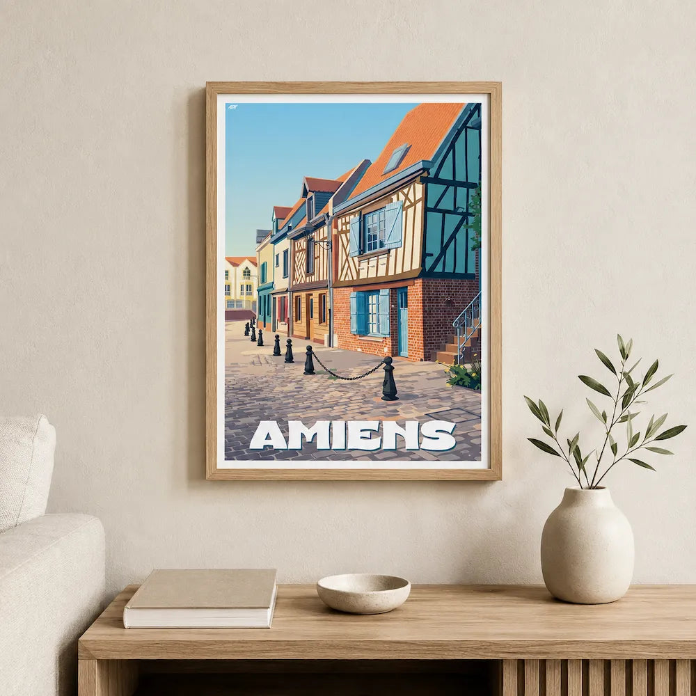 Poster d'art d'Amiens sous cadre posé sur une console moderne en bois clair dans une entrée