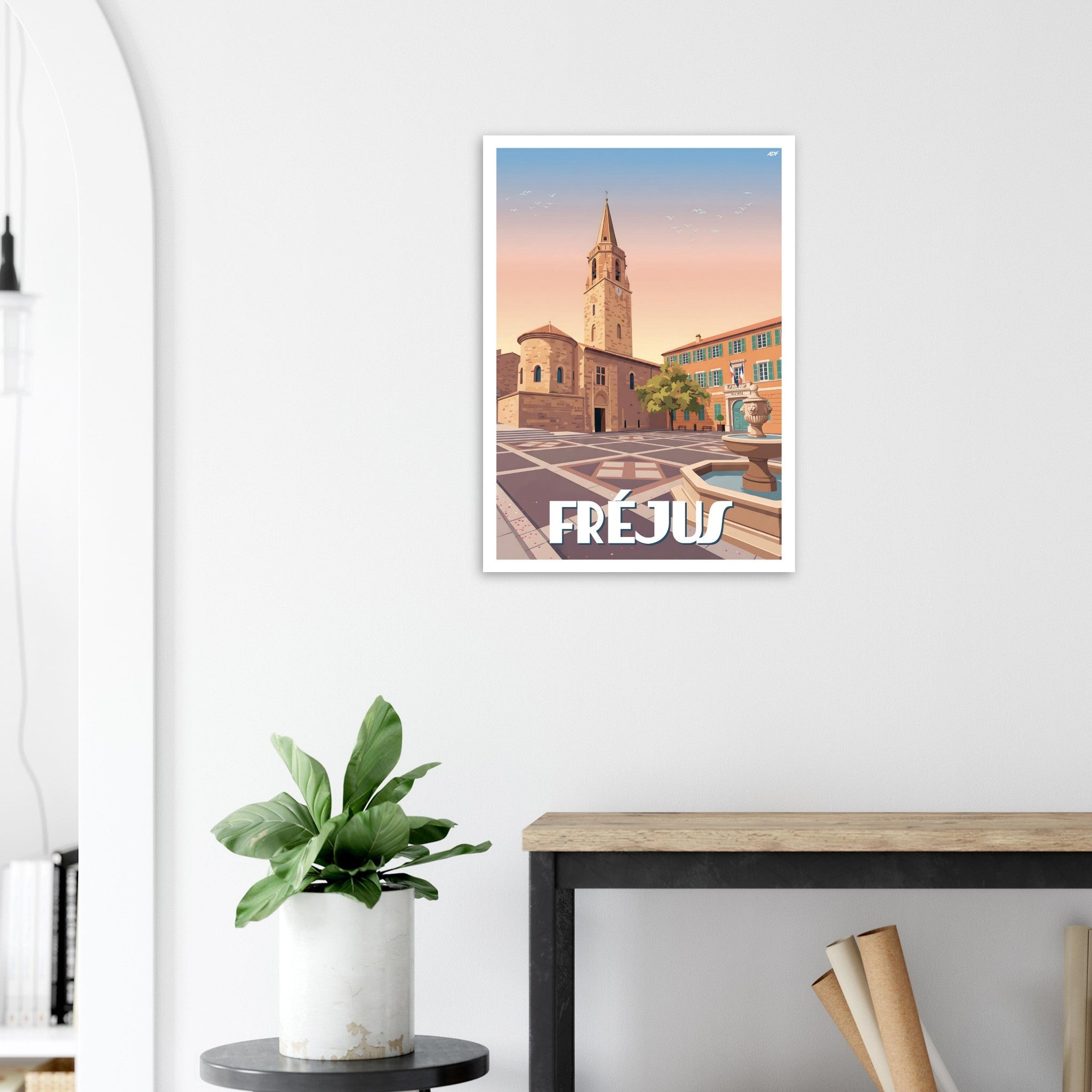 Poster de voyage de Fréjus sous cadre posé sur une console en bois moderne dans une entrée