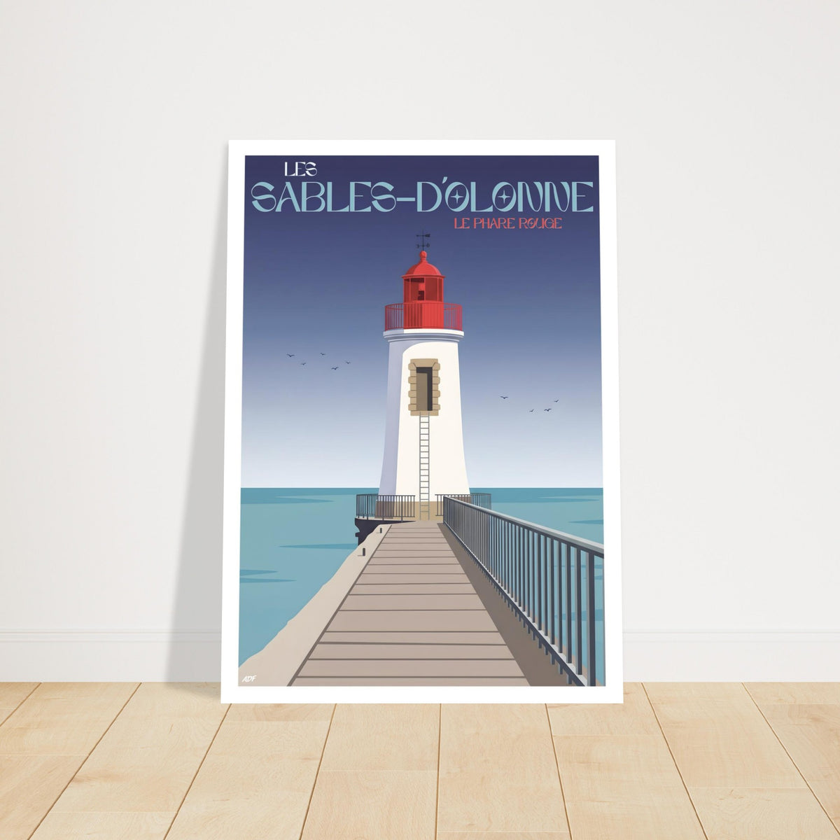 Grand tirage d'art sous cadre du phare des Sables-d'Olonne posé au sol sur parquet en bois
