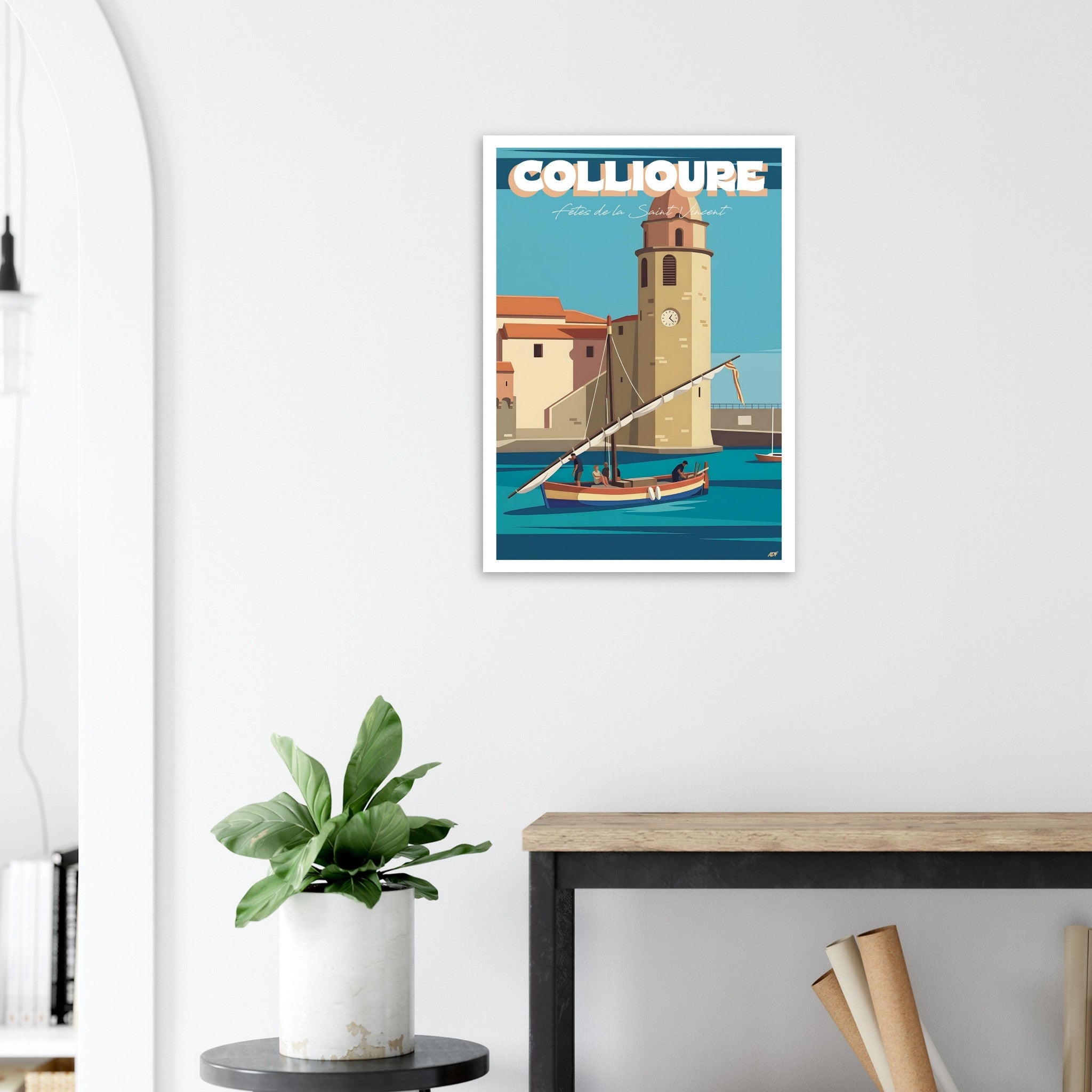 Décoration murale lumineuse avec le poster illustré de Collioure au-dessus d'une table à manger