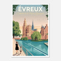 Poster d'Évreux sous cadre en bois clair posé sur une commode blanche près d'un vase en céramique