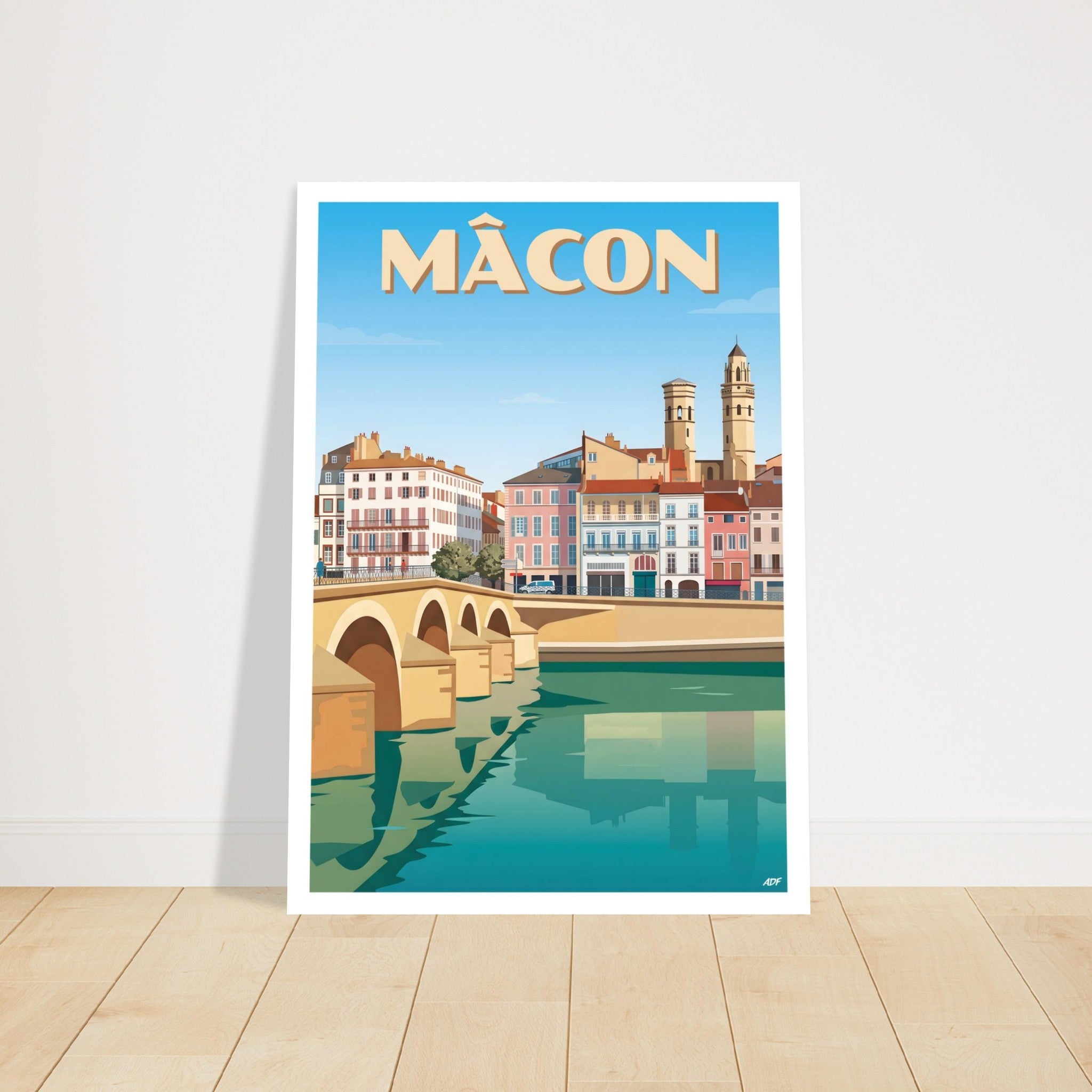 Grand tirage d'art encadré de Mâcon posé au sol sur parquet en bois